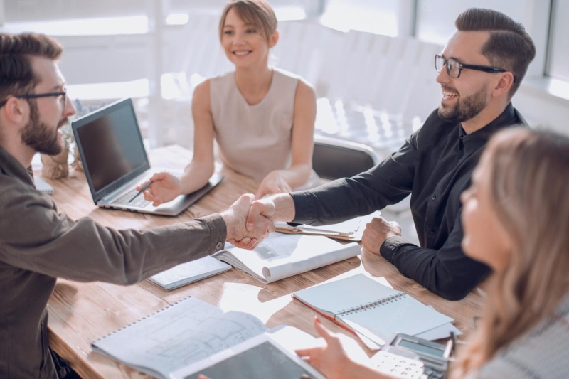 smiling-business-partners-shaking-hands-business-meeting_252847-494 (1)